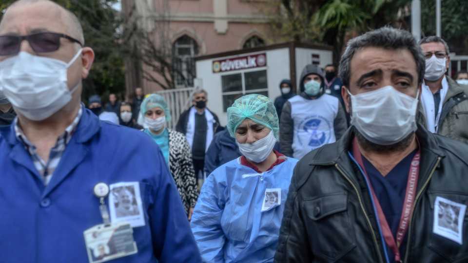 Health workers mourn outside Istanbul University Faculty of Medicine during a commemoration for professor Cemil Tascooglu, the country's first medical professional to pass away from the Covid-19 disease, on April 2, 2020, in Istanbul.
