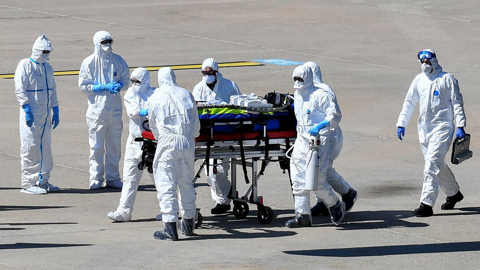 Medical staff loads a patient infected with the Covid-19 into an ambulance after disembarking from an helicopter at the Nimes air base, south of France, on April 4, 2020.