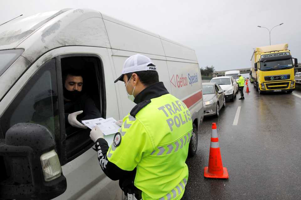 Turkish Police officers ask for travel permits on a highway near Istanbul after the government decided to shut down the borders of 31 cities for all vehicles excluding transit passage for essential supplies, as the spread of coronavirus disease (COVID-19) continues, at the outskirts of Istanbul, Turkey April 4, 2020.