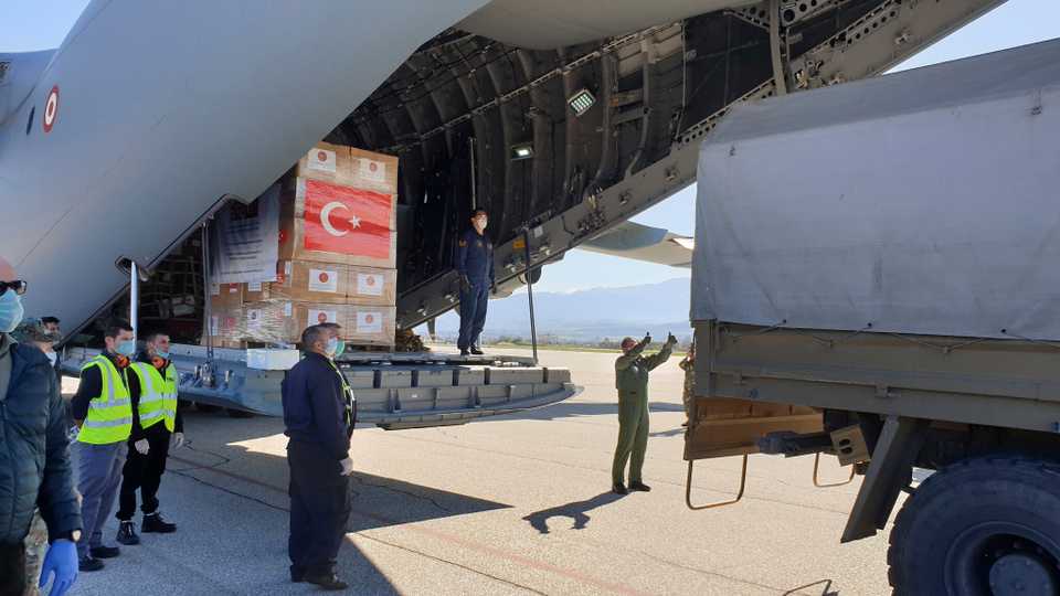 In this handout photo provided by the Turkish Defence Ministry, North Macedonian officials unload Personal Protection Equipment donated by Turkey to help the country combat the coronavirus outbreak, April 8, 2020.
