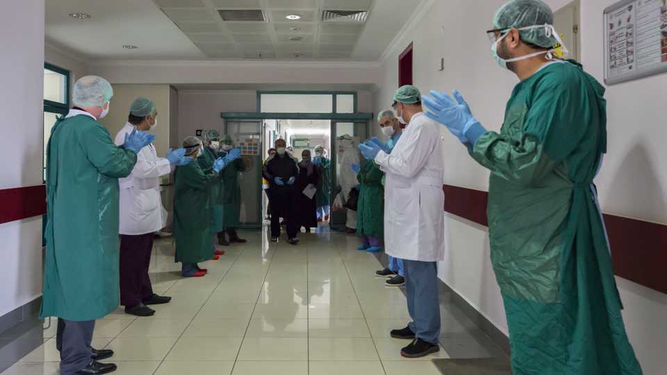 Picture shows medical workers applauding after five people recovered from Covid-19 and discharged from a hospital in Diyarbakir, Turkey.