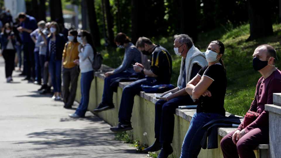 People keep social distance while waiting in line to be tested for the coronavirus disease (COVID-19) as a part of a study about undetected infections with the coronavirus in the population in Prague, Czech Republic on April 23, 2020