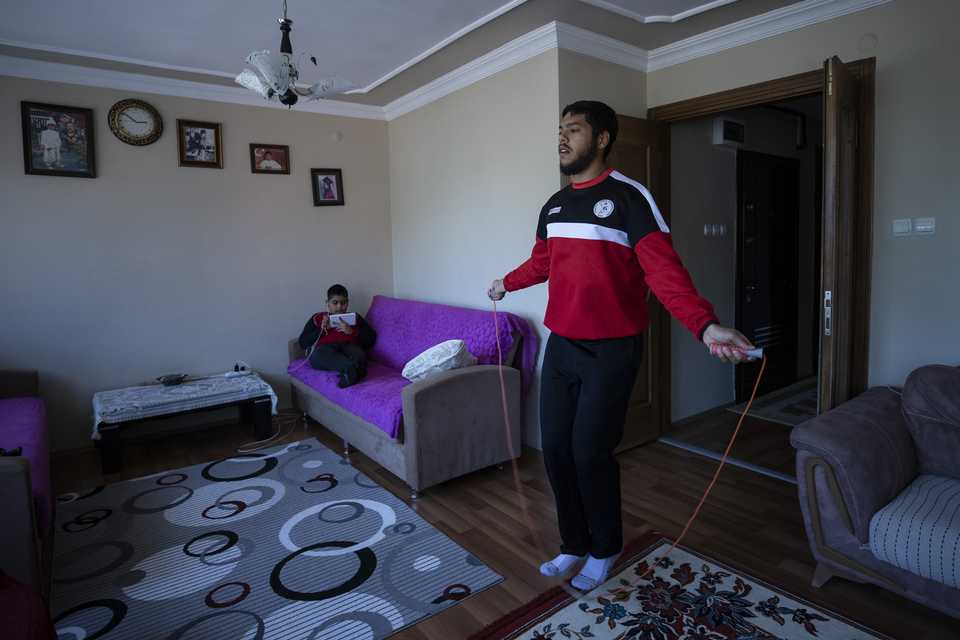 Wrestler Arifcan Domuzcu trains inside his house in Edirne, Turkey.