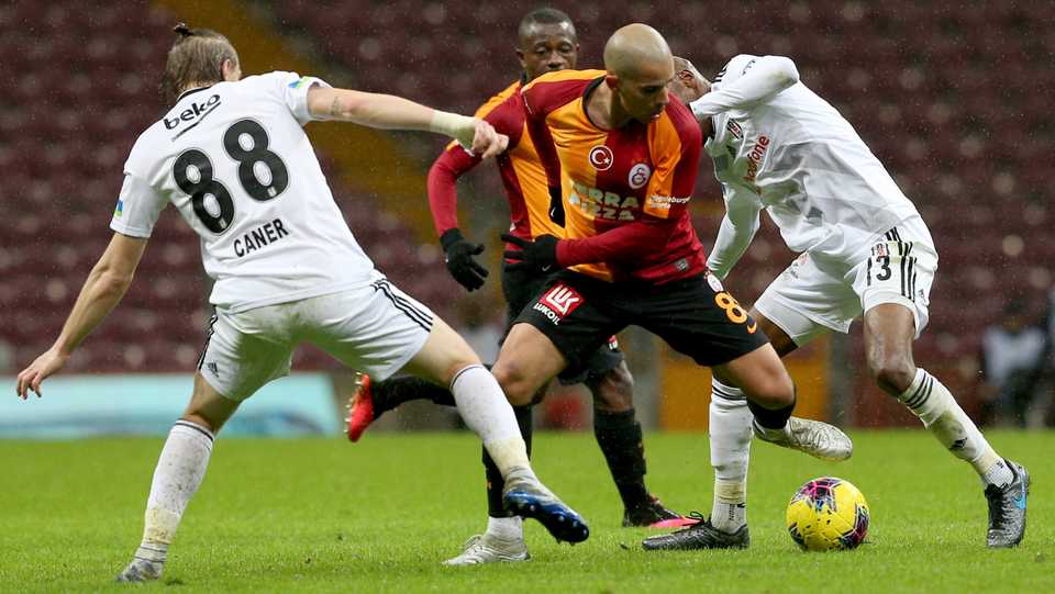 In this file photo, Sofiane Feghouli (2nd R) of Galatasaray in action against Atiba (R) and Caner Erkin (88) of Besiktas during the Turkish Super Lig week 26 football match between Galatasaray and Besiktas, being played behind closed doors over coronavirus concerns on March 15, 2020 at Turk Telekom Stadium in Istanbul, Turkey.