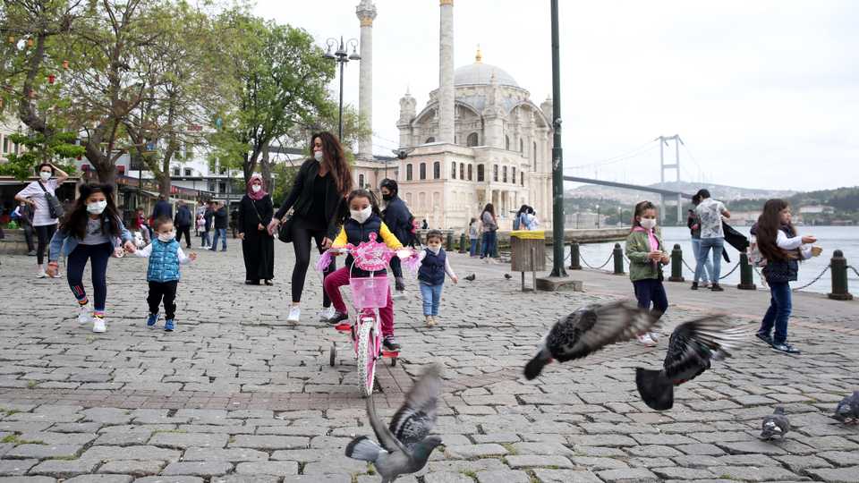Children play at Ortakoy Square in Istanbul, Turkey on May 13, 2020.