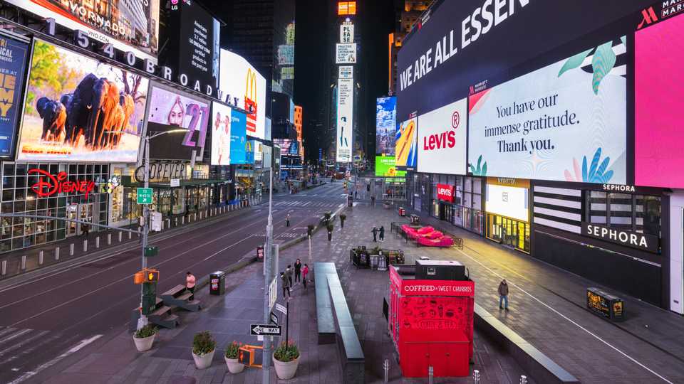 A handful of pedestrians walk through Times Square as streets remain relatively quiet due to the continuing outbreak of the coronavirus disease (Covid-19) in the Manhattan borough of New York US, May 5, 2020.