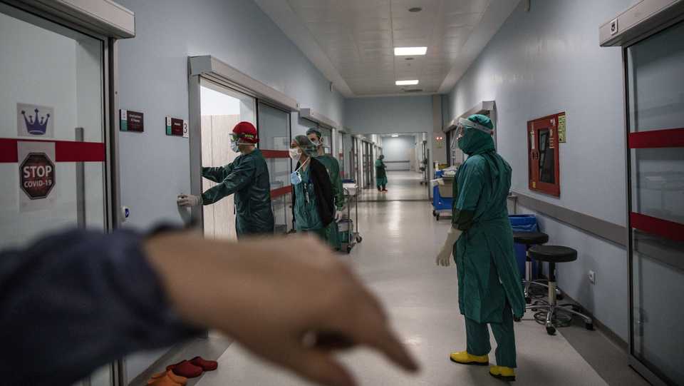 Health workers wearing personal protection equipment carry an emergency patient diagnosed with coronavirus to an operating room at the Martyr Prof. Dr. Ilhan Varank Training and Research Hospital in Istanbul, Turkey on May 12, 2020.