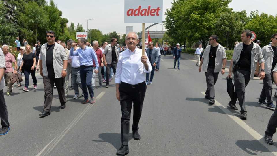 Turkey's main opposition Republican People's Party (CHP) leader Kemal Kilicdaroglu walks during a protest against detention of Republican People's Party (CHP) lawmaker Enis Berberoglu, in Ankara, Turkey, June 15, 2017. The placard reads "Justice".