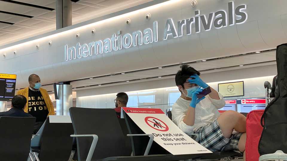 Passengers wearing protective face masks are seen at Heathrow Airport, amid the coronavirus disease (Covid-19) outbreak in London, Britain, May 22, 2020.