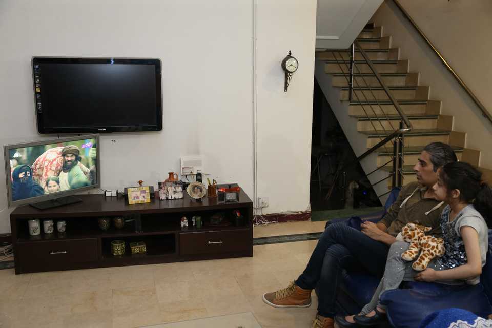 This image shows a Pakistani family watching the Turkish drama.