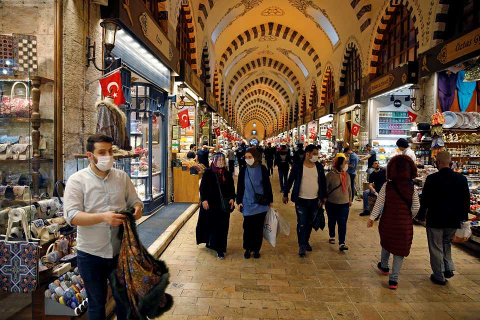 People wearing protective face masks walk at the spice market, also known as the Egyptian Bazaar in Turkish, as it reopens after weeks of closure due to the coronavirus disease pandemic, in Istanbul, Turkey, June 1, 2020.