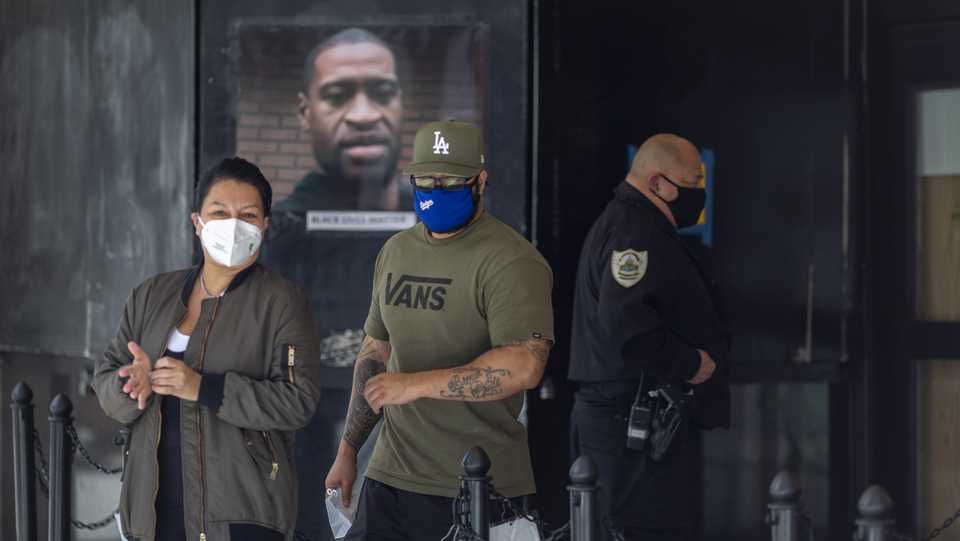 A photo of George Floyd is seen attached to the Saint Vincent Jewelry Center as people continue to protest the killing of George Floyd despite the dangers of the widening coronavirus pandemic on June 6, 2020 in Los Angeles, California.