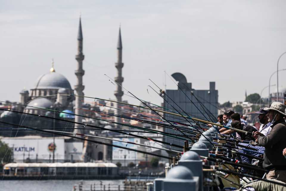 People neglect social distancing rules while fishing at the Galata bridge during the first weekend without curfew imposed since April 10 to stem the spread of coronavirus pandemic in Istanbul, Turkey on June 6, 2020.