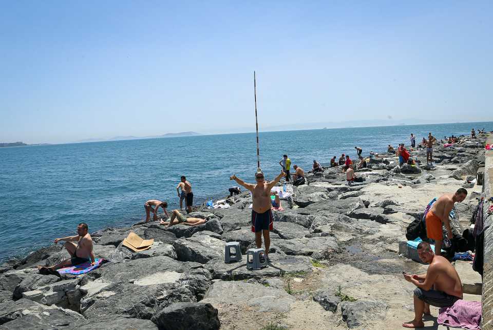 People sunbathe as they spend their time at Sarayburnu coast during the first weekend without the novel coronavirus pandemic restrictions since 10th April, in Istanbul, Turkey on June 07, 2020.