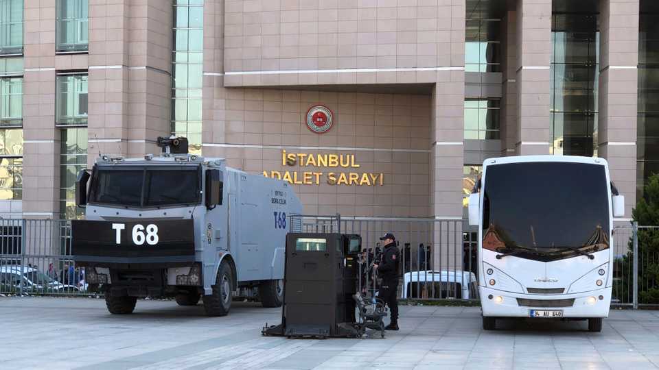 FILE PHOTO: Security cars and an official stand outside the Justice Palace as a trial against Metin Topuz, a Turkish employee of the United States Consulate in Istanbul charged with espionage and attempting to overthrow the Turkish government, began in Istanbul, on March 26, 2019.