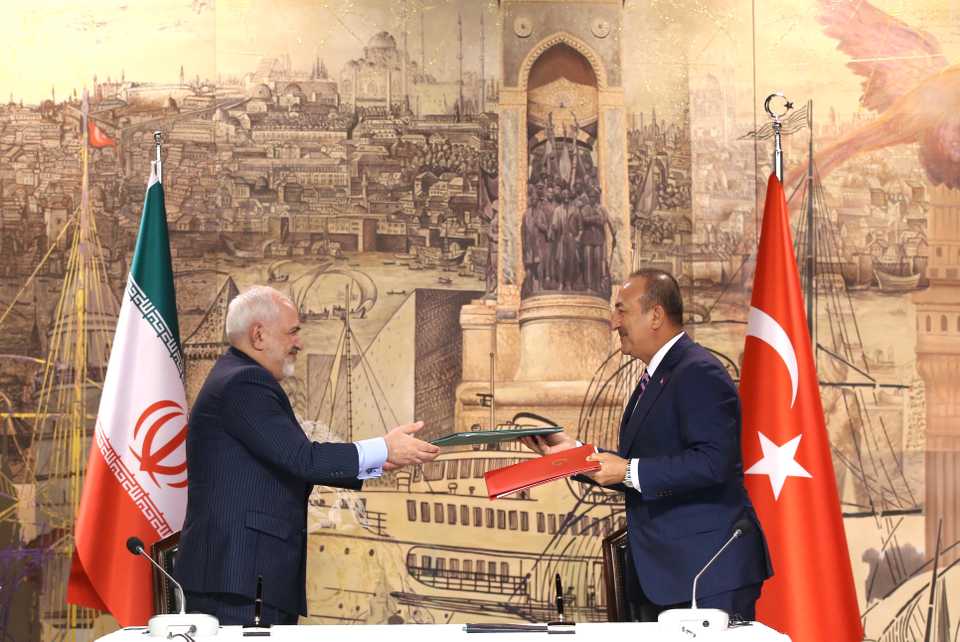 Turkish Foreign Minister Mevlut Cavusoglu (R) and Iranian Foreign Minister Javad Zarif (L) hold a signing ceremony and press conference after their meeting at the Dolmabahce Palace Presidential Work Office in Istanbul, Turkey on June 15, 2020.