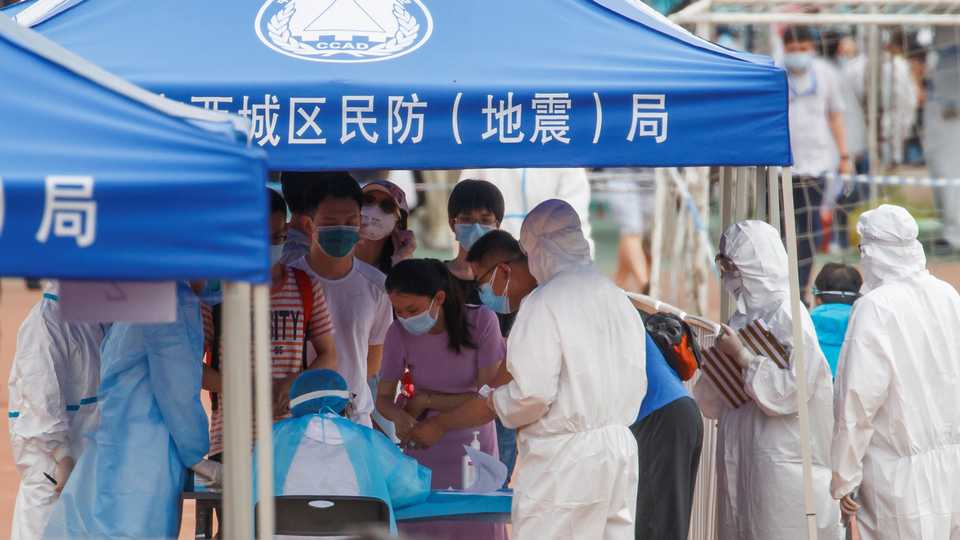 People line up to get tested at the Guangan Sport Center after an unexpected spike of cases of the coronavirus disease (Covid-19) in Beijing, China June 15, 2020.