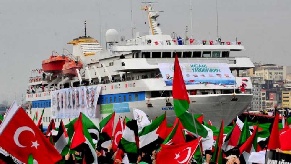 Turkish ship Mavi Marmara arrives at Sarayburnu port as people wave Turkish and Palestinian flags, on December 26, 2010. 
