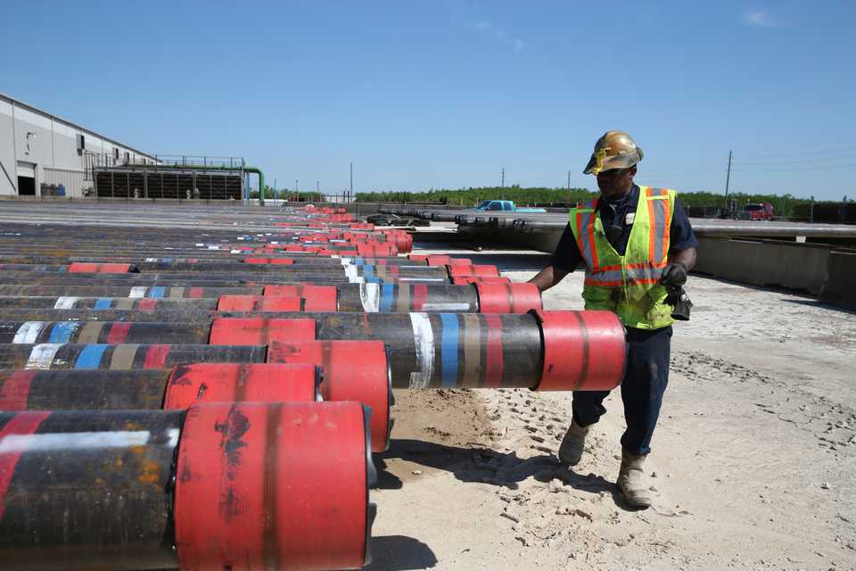 Taurice Jones, an American employee, inspects steel pipes as part of quality control at the Borusan Mannesmann plant, whose parent company is located in Turkey, in Baytown, Texas, April 23, 2018.