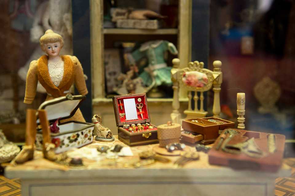 A late19th century German dollhouse displaying a tailor and her wares.