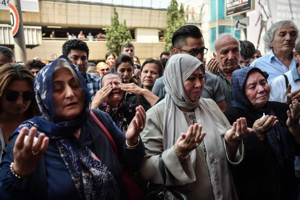 The relatives of the victims pray during a memorial ceremony at the Istanbul Ataturk International Airport. 