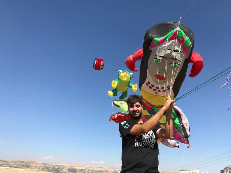 Zahit Mungan with the kite he made of the mythical creature Shahmaran, half woman, half snake.