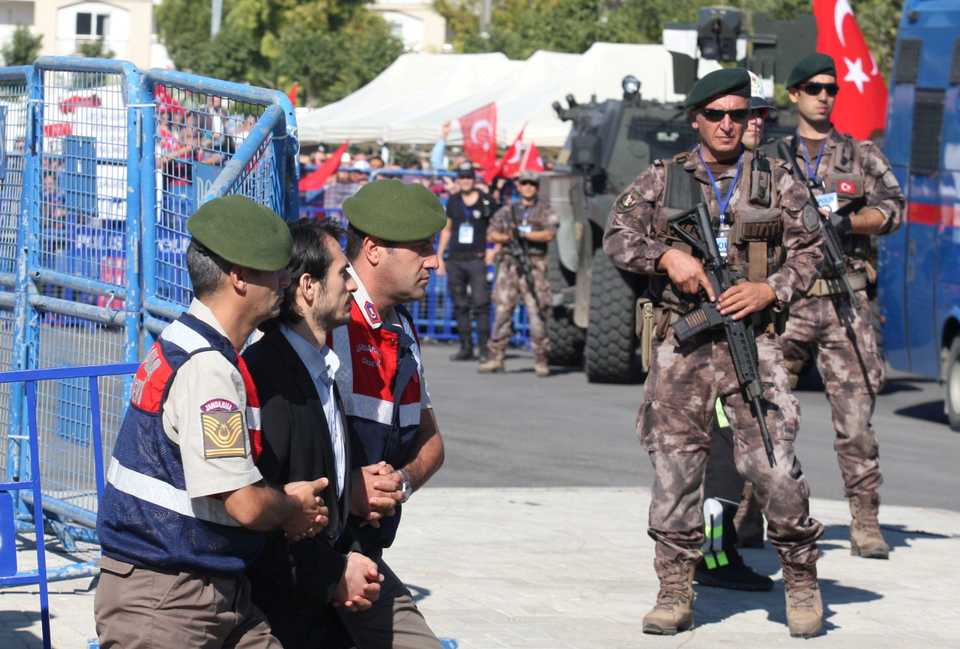 An unidentified soldier accused of attempting to assassinate Turkish President Recep Tayyip Erdogan on the night of the failed last year's July 15 coup, is escorted by gendarmes as he leaves from the final hearing of the trial in Mugla, Turkey, October 4, 2017.