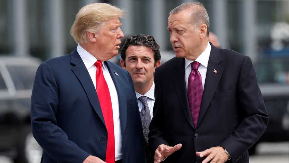 US President Trump and Turkey's President Erdogan gesture as they talk at the start of the NATO summit in Brussels, Belgium, July 11, 2018.