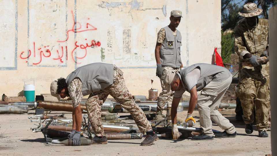 Military engineers sort ammunition and explosives, uncovered from areas south of the capital, ahead of disposing of them in the Libyan capital Tripoli on July 22, 2020.