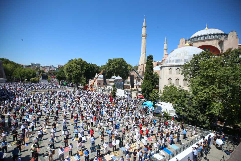 People perform Friday Prayer, which is performed for the first time after 86 years, outside of the Hagia Sophia Mosque on July 24, 2020 in Istanbul, Turkey.