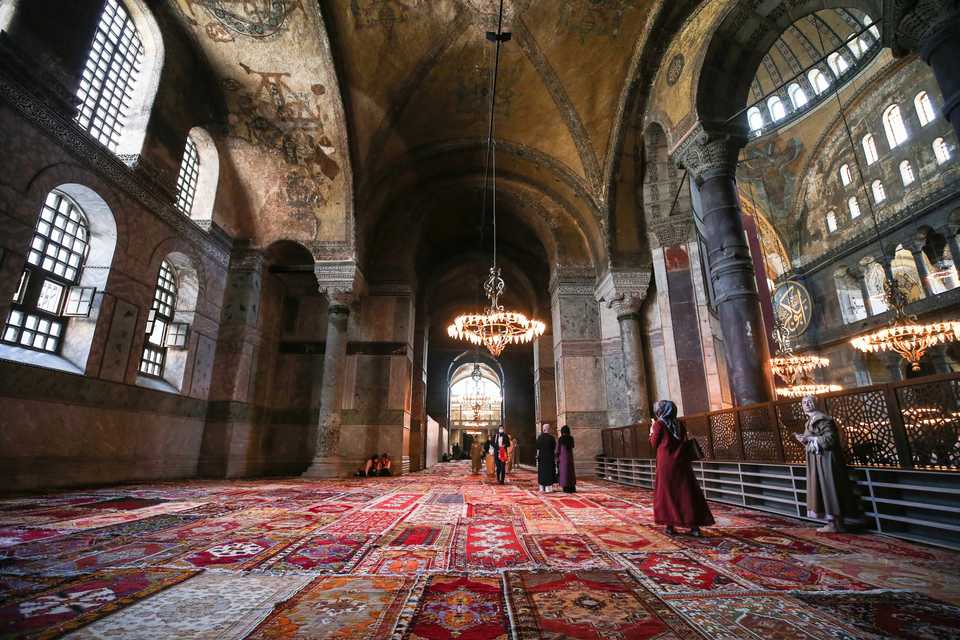 Women visit Hagia Sophia Grand Mosque, and walk on new carpet laid down for prayer in Istanbul, Turkey on July 24, 2020.