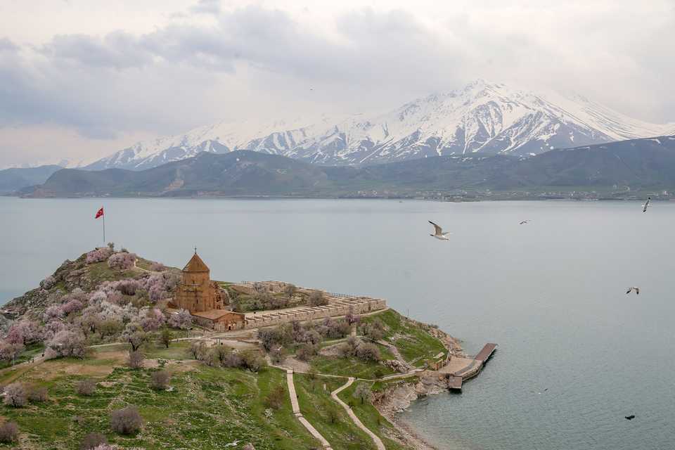 A general view of the Akdamar Island, the second largest of the four islands in Lake Van, along with blooming almond trees in Van, Turkey on April 24, 2020.