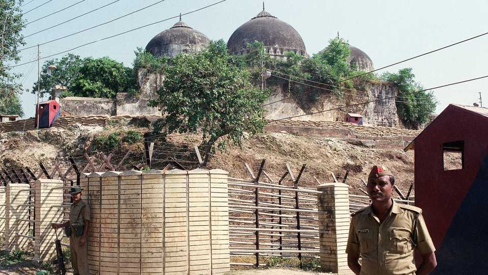 In this Oct. 29, 1990, file photo, Indian security officer guards the Babri Mosque in Ayodhya, closing off the disputed site claimed by Muslims and Hindus.