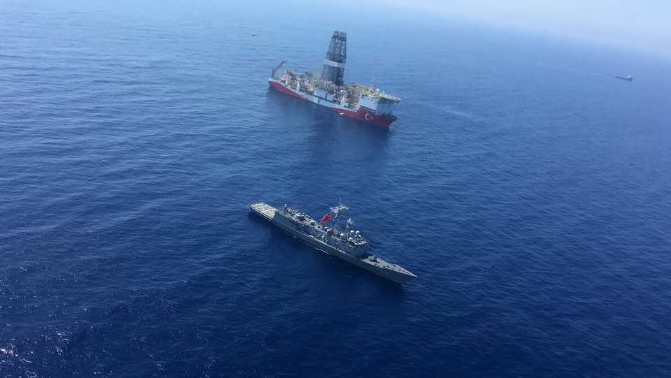 An aerial photo shows Turkish drill ship Fatih continue offshore drilling operations next to a Turkish battleship off the west coast of Cyprus.