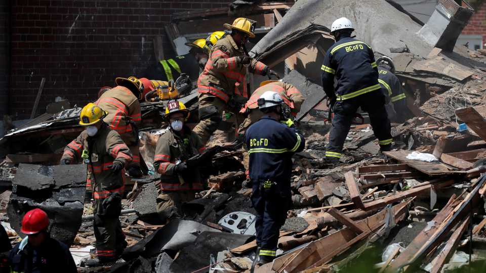 Fire fighters look for survivors at the scene of an explosion in a residential area of Baltimore, Maryland, US, August 10, 2020.