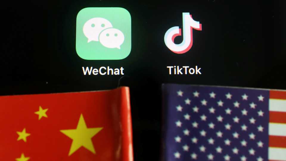 The messenger app WeChat and short-video app TikTok are seen near China and US flags in this illustration picture taken August 7, 2020.