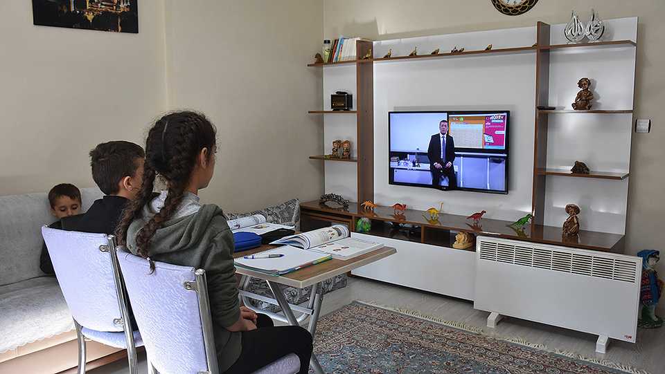 Children watch from home as Turkish Education Minister Ziya Selcuk gives a lesson during a remote education programme that started in March due to Covid-19 pandemic.