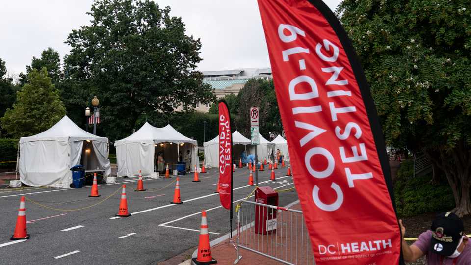 Members with the Washington, DC Dept. of Health administer Covid-19 tests on F Street. August 14, 2020.