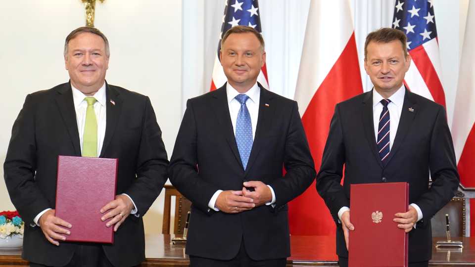 US Secretary of State Mike Pompeo, left, Poland's President Andrzej Duda, centre, and Poland's Defence Minister Mariusz Blaszczak after signing the US-Poland Enhanced Defence Cooperation Agreement in Warsaw, Poland, August 15, 2020.