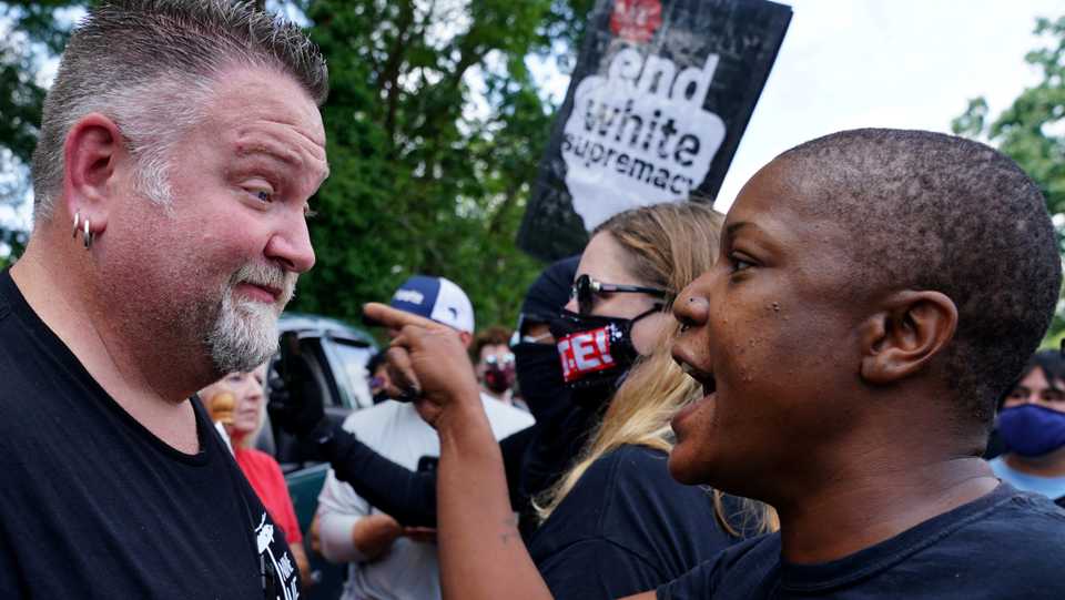 Protesters exchange words as various militia groups stage rallies at the Confederate memorial at Stone Mountain, Georgia, US August 15, 2020.