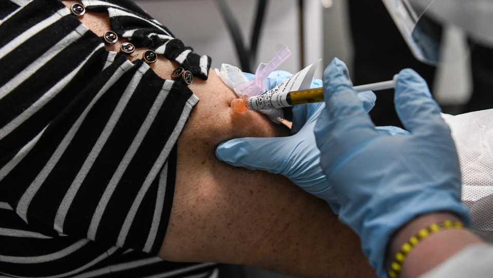 Sandra Rodriguez, 63, receives a Covid-19 vaccination from Yaquelin De La Cruz at the Research Centers of America (RCA) in Hollywood, Florida, on August 13, 2020.