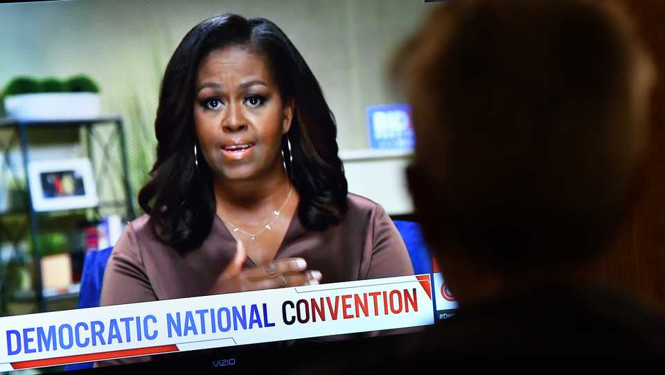 A person watches former First Lady Michelle Obama speak during the opening night of the Democratic National Convention, being held virtually amid the novel coronavirus pandemic, in Los Angeles, on August 17, 2020.