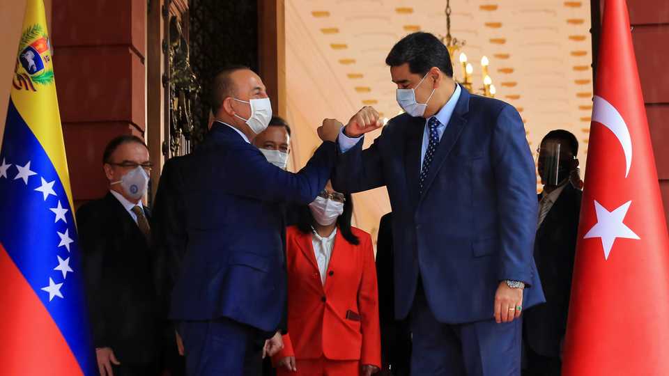 Venezuela's President Nicolas Maduro and Turkish Foreign Minister Mevlut Cavusoglu, wearing protective masks, meet at Miraflores Palace in Caracas, Venezuela August 18, 2020.