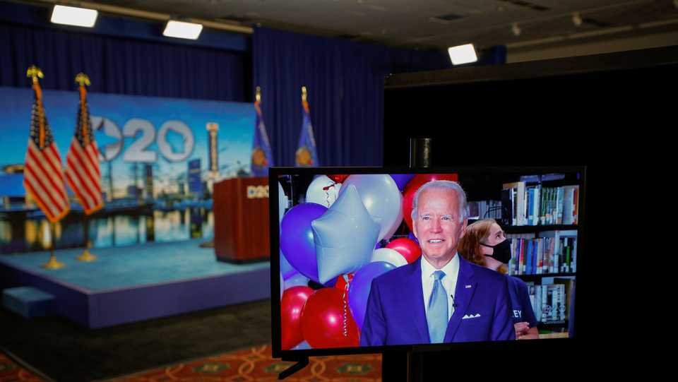 Joe Biden is seen onscreen in a video feed from Delaware, after winning the votes to become the Democratic Party’s 2020 nominee for president, at the Wisconsin Center in Milwaukee, Wisconsin, US. August 18, 2020.