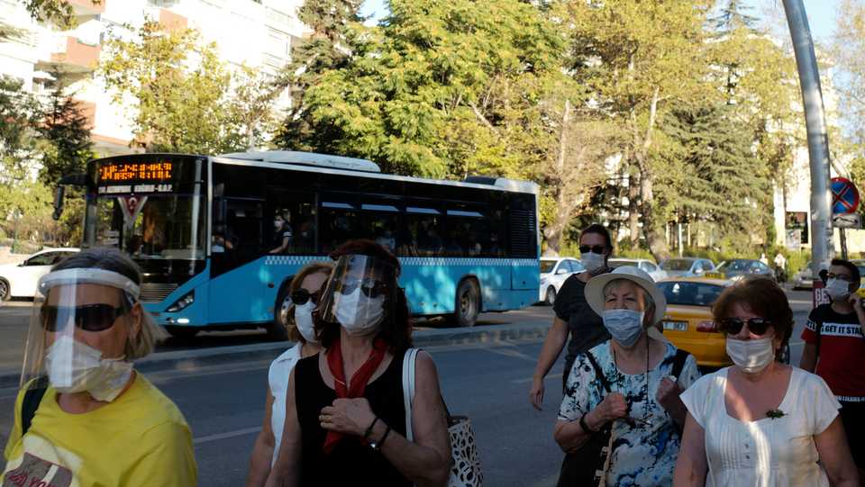 People wearing face masks to protect against the spread of coronavirus, walk in Ankara, Turkey, August 17, 2020.