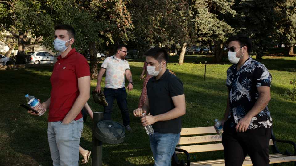 People wearing face masks to protect against the spread of coronavirus, walk in a public garden, in Ankara, Turkey. August 17, 2020.