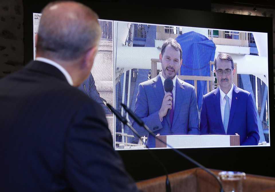 Turkish President Recep Tayyip Erdogan listening to Turkish Finance Minister Berat Albayrak and Energy Minister Fatih Donmez during a video-conference in Istanbul, Turkey, August 21, 2020.
