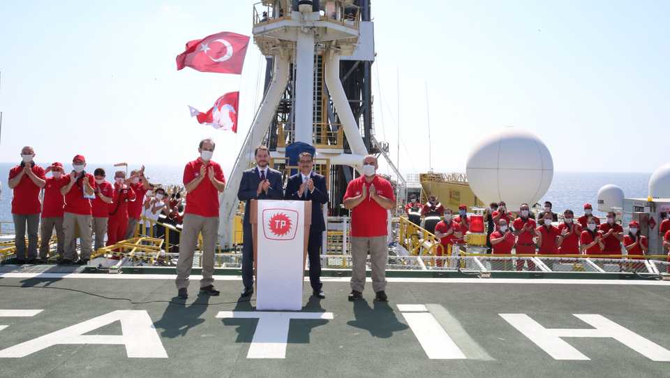 Turkish Finance Minister Berat Albayrak and Energy Minister Fatih Donmez applaud on the deck of drilling vessel Fatih in the western Black Sea, off Turkey on August 21, 2020.