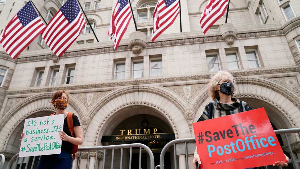 Protestors wearing face masks rally in support of the United States Postal Service (USPS) outside the Trump International Hotel in Washington, US August 22, 2020.