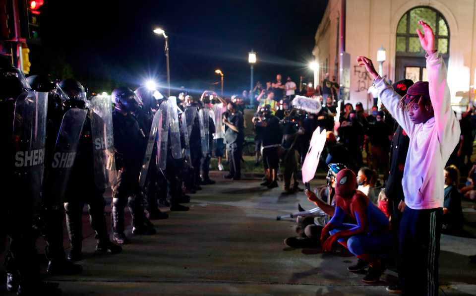Protestors face off with police outside the County Courthouse during demonstrations against the shooting of Jacob Blake in Kenosha, Wisconsin on August 25, 2020.